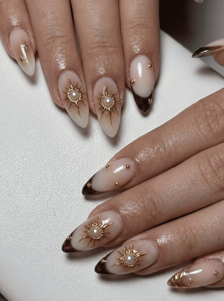 Champagne nude almond nails with gold sunburst and pearls at Ivory Nail Boutique, Victoria BC