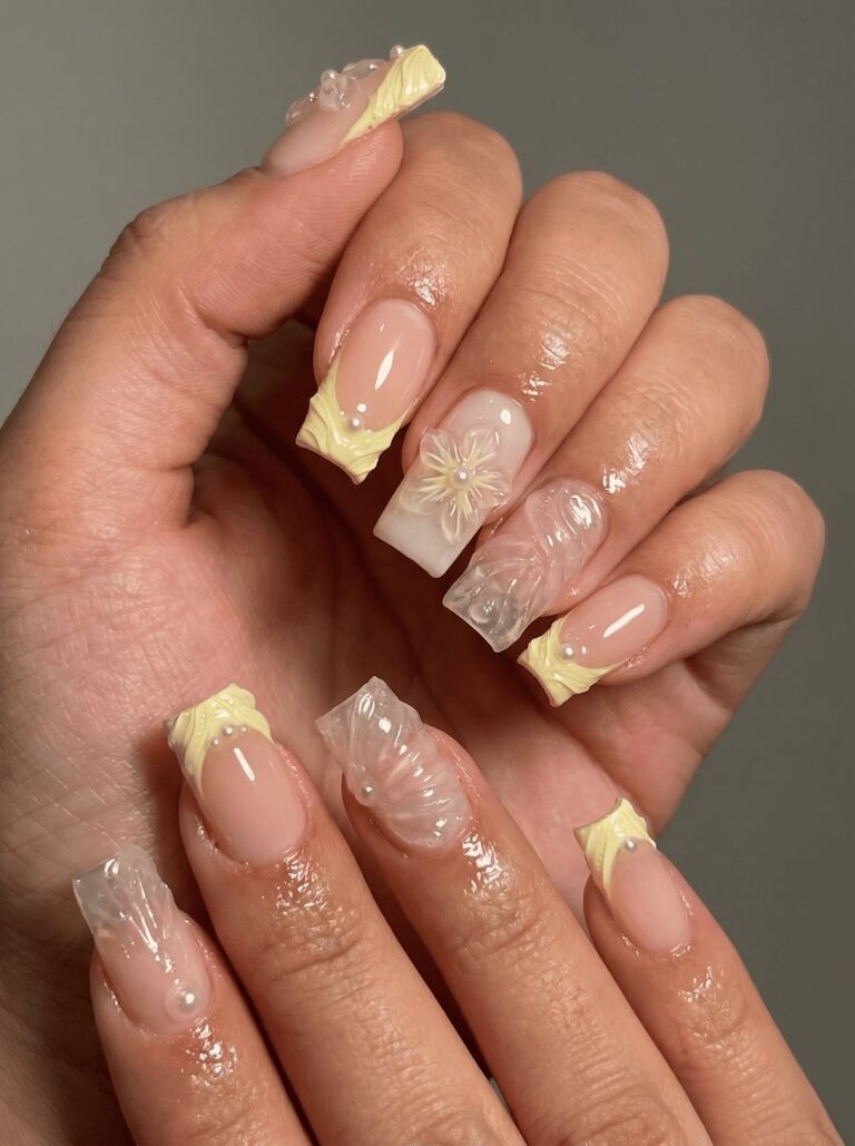 Pastel French nails with white florals and pearl detailing at Ivory Nail Boutique