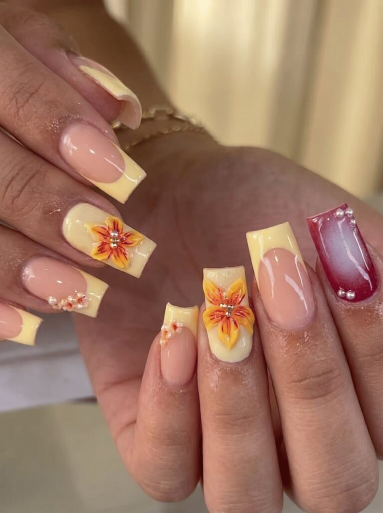 Yellow French tip nails with hand-painted floral art at Ivory Nail Boutique, Victoria